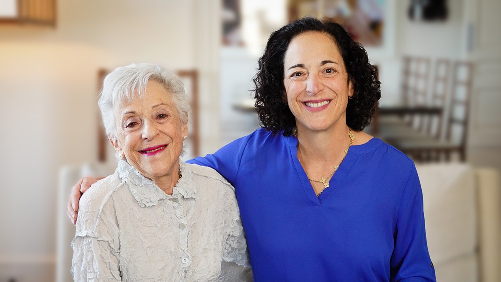 Philanthropists Lynn Schusterman (left) and daughter Stacy Schusterman (right) smile, with Stacy’s arm around Lynn’s shoulders.
