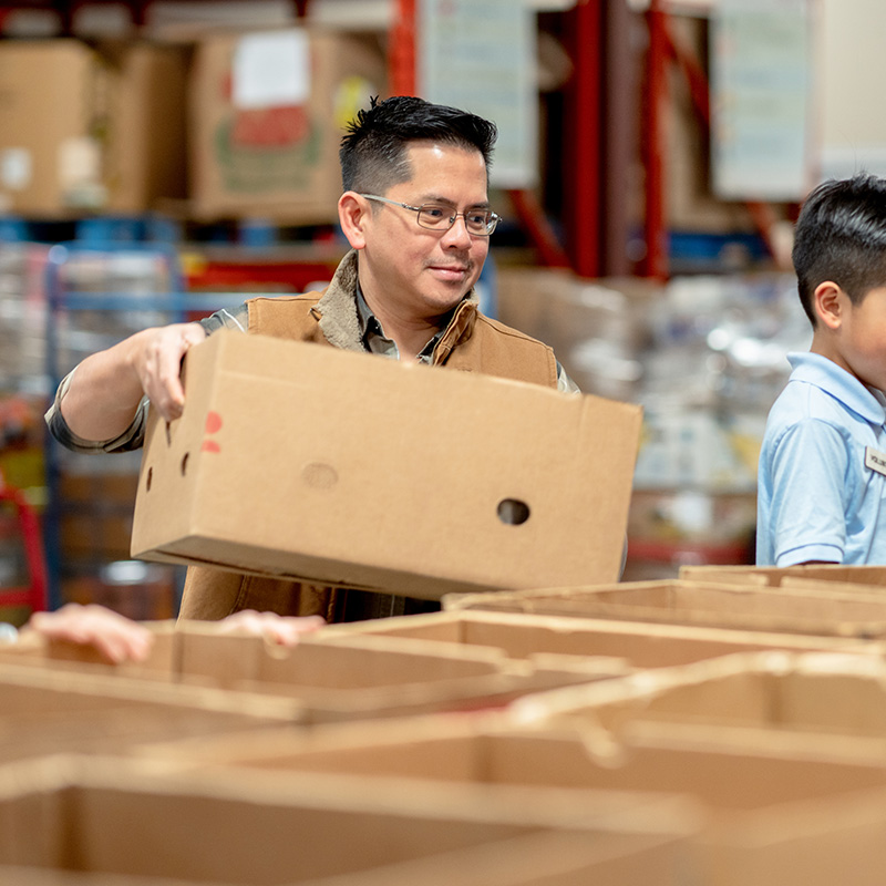 A man moves a box as he helps out at a local food bank.